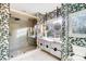 Modern bathroom featuring dual sinks, marble countertops, and a glass-enclosed shower at 6610 Rolling Ridge Dr, Waxhaw, NC 28173