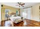 Sunlit bedroom with hardwood floors, a comfortable bed, and bright windows at 6610 Rolling Ridge Dr, Waxhaw, NC 28173