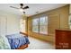 Comfortable bedroom with a wooden bed frame, large window, and natural light at 6610 Rolling Ridge Dr, Waxhaw, NC 28173