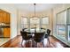 Breakfast nook with glass table and chairs, hardwood floors at 6610 Rolling Ridge Dr, Waxhaw, NC 28173