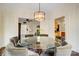 Elegant dining room features a round glass table, seating for six, and stylish chandelier at 6610 Rolling Ridge Dr, Waxhaw, NC 28173