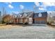 Spacious brick home with a metal roof, a two-car garage, and a circular driveway at 6610 Rolling Ridge Dr, Waxhaw, NC 28173