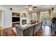 Inviting living room featuring a fireplace, hardwood floors, large windows, and comfortable seating at 6610 Rolling Ridge Dr, Waxhaw, NC 28173