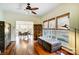 Open-concept room with hardwood floors and multiple windows, with dining room in background at 6610 Rolling Ridge Dr, Waxhaw, NC 28173