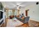 Spacious living room with hardwood floors, large sofa, bright windows, and a ceiling fan at 6610 Rolling Ridge Dr, Waxhaw, NC 28173