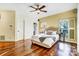 Cozy main bedroom with a ceiling fan, hardwood floors, and sun-filled windows at 6610 Rolling Ridge Dr, Waxhaw, NC 28173