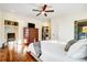 Sun-drenched bedroom with hardwood floors, ceiling fan, and access to a luxurious bathroom at 6610 Rolling Ridge Dr, Waxhaw, NC 28173