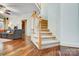 Inviting staircase leading to upper level, with hardwood floors and a comfortable living room nearby at 6610 Rolling Ridge Dr, Waxhaw, NC 28173