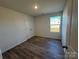 Simple bedroom with wood-look floors and a window at 168 Salem Springs Ln, Statesville, NC 28625