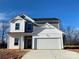 Two-story house with gray and white siding, white garage door, and landscaping at 168 Salem Springs Ln, Statesville, NC 28625
