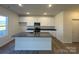 Modern kitchen with white cabinets, granite island, and stainless steel appliances at 168 Salem Springs Ln, Statesville, NC 28625