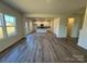 Open living room with kitchen view and wood-look flooring at 168 Salem Springs Ln, Statesville, NC 28625