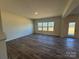 Spacious living room with large windows and wood-look flooring at 168 Salem Springs Ln, Statesville, NC 28625