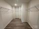 Large walk-in closet with wire shelving and wood-look floors at 168 Salem Springs Ln, Statesville, NC 28625