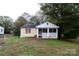 Charming single-story home with a covered porch and well-maintained lawn surrounded by mature trees at 1840 Findlay St, Gastonia, NC 28052
