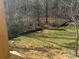 A level backyard that gently slopes away from the home into a wooded area at 200 Fostoria Pl # 78A, Albemarle, NC 28001