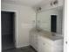 Bathroom featuring a double vanity, granite countertop, stylish fixtures, and a large mirror at 200 Fostoria Pl # 78A, Albemarle, NC 28001