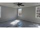 Spacious bedroom with a ceiling fan, carpet, and multiple windows for natural light at 200 Fostoria Pl # 78A, Albemarle, NC 28001