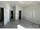 A bedroom with an open doorway and bathroom under construction in a new home at 200 Fostoria Pl # 78A, Albemarle, NC 28001