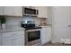 Stainless steel appliances and white cabinets in kitchen at 200 Fostoria Pl # 78A, Albemarle, NC 28001