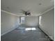 Spacious primary bedroom features carpet, ceiling fan, and windows for natural light at 200 Fostoria Pl # 78A, Albemarle, NC 28001