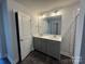 Bathroom boasts double vanity with gray cabinets and quartz countertop at 202 Fostoria Pl # 78B, Albemarle, NC 28001