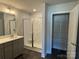 Modern bathroom featuring a tiled shower with glass door and a vanity with sink at 202 Fostoria Pl # 78B, Albemarle, NC 28001