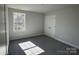 Bedroom featuring carpet, a window, and double doors to a closet at 202 Fostoria Pl # 78B, Albemarle, NC 28001