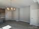 Dining area with vinyl flooring, contemporary lighting, and neutral paint at 202 Fostoria Pl # 78B, Albemarle, NC 28001