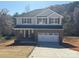 New two-story home with a brick facade, gray siding and two-car garage at 202 Fostoria Pl # 78B, Albemarle, NC 28001