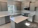 Modern kitchen featuring gray cabinets, subway tile backsplash, island and stainless steel appliances at 202 Fostoria Pl # 78B, Albemarle, NC 28001