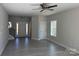 Bright, open-concept living room featuring vinyl floors, large windows, and modern ceiling fan at 202 Fostoria Pl # 78B, Albemarle, NC 28001