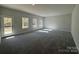 Bright living room featuring a plush carpet, neutral paint, and multiple windows at 202 Fostoria Pl # 78B, Albemarle, NC 28001