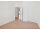 Clean bedroom featuring hardwood floors, white walls, and an open doorway leading to another room at 2234 Millennium Dr # 84, Lancaster, SC 29720