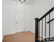Bright entryway featuring hardwood floors, a white front door, and a staircase with a black railing at 2234 Millennium Dr # 84, Lancaster, SC 29720