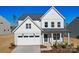 Beautiful two-story home featuring white and gray siding, a covered porch, and a two-car garage at 2234 Millennium Dr # 84, Lancaster, SC 29720