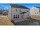Rear exterior view of a gray two-story home with a covered patio and freshly laid lawn at 2234 Millennium Dr # 84, Lancaster, SC 29720