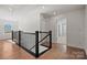 Bright hallway features hardwood floors and black railing at 2234 Millennium Dr # 84, Lancaster, SC 29720