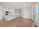 Bright, open-concept living space featuring hardwood floors and a modern kitchen with an island and stainless appliances at 2234 Millennium Dr # 84, Lancaster, SC 29720