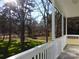 White porch overlooks a grassy backyard with mature trees at 2270 Charlotte Hwy, York, SC 29745