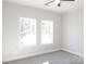 Bright bedroom with carpet flooring and two large windows at 2270 Charlotte Hwy, York, SC 29745