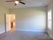 Bedroom with ceiling fan, carpeted floors, and an adjacent bathroom at 2270 Charlotte Hwy, York, SC 29745