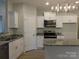 Modern kitchen with white cabinets, granite countertops, and stainless steel appliances at 2270 Charlotte Hwy, York, SC 29745
