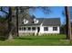 Charming white home with black shutters, dormers, and welcoming front porch framed by mature trees at 2270 Charlotte Hwy, York, SC 29745