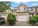 Attractive townhome featuring a one car garage, neat landscaping, and shuttered windows at 310 Rose Garden Ct, Rock Hill, SC 29732