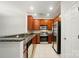 Modern kitchen features stainless steel appliances and warm wood cabinetry at 310 Rose Garden Ct, Rock Hill, SC 29732