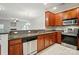 Well-lit kitchen featuring granite countertops, stainless steel appliances and wood cabinetry at 310 Rose Garden Ct, Rock Hill, SC 29732