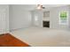 Cozy living room with a fireplace, natural light, and neutral carpet at 310 Rose Garden Ct, Rock Hill, SC 29732