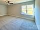 Spacious bedroom featuring plush carpeting, a ceiling fan, and a window offering ample natural light at 3850 Willow Grove Ln # 24, Concord, NC 28025