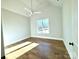 Bright bedroom featuring hardwood floors, ceiling fan and a large window at 3850 Willow Grove Ln # 24, Concord, NC 28025